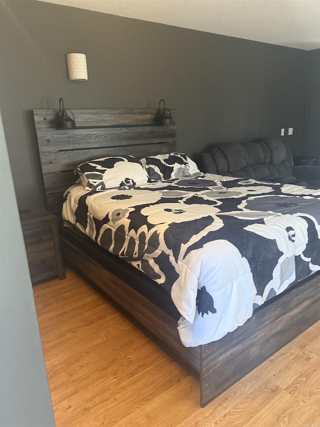 bedroom with wood finished floors