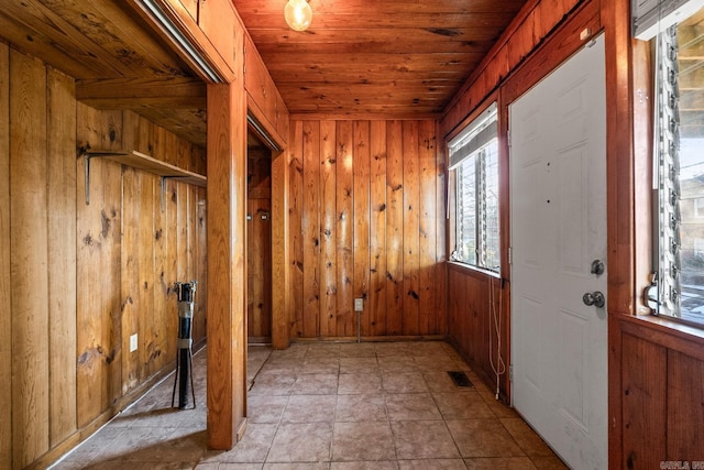 entryway with wood ceiling and wooden walls