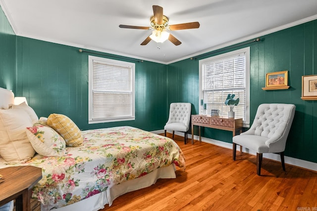 bedroom with ceiling fan, hardwood / wood-style flooring, and crown molding