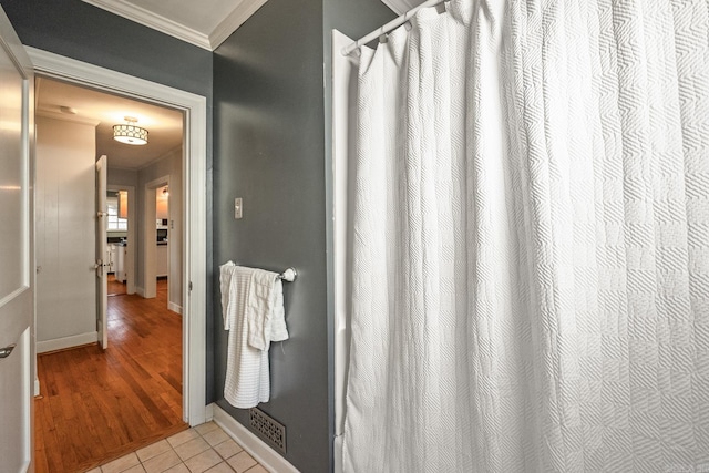 bathroom featuring crown molding and tile patterned floors