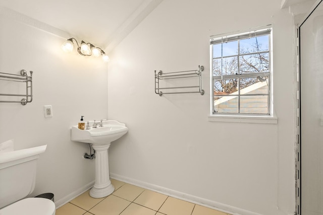 bathroom with toilet and tile patterned flooring