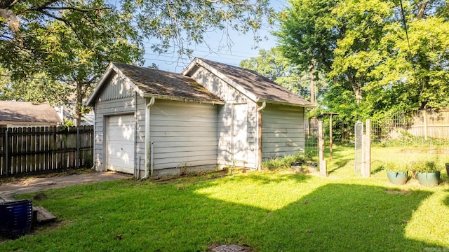 view of outbuilding with a lawn and a garage