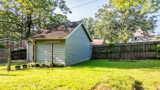 view of outbuilding with a yard