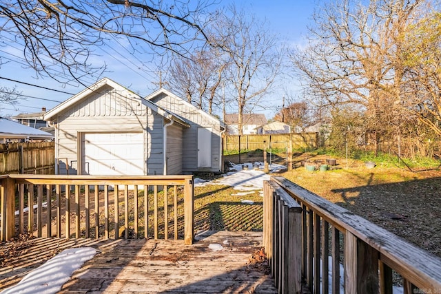 wooden deck featuring an outdoor structure and a garage