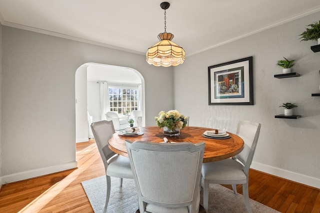 dining room featuring ornamental molding and light hardwood / wood-style flooring