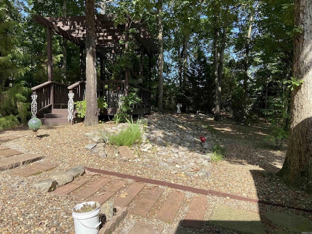 view of yard featuring a deck and a pergola