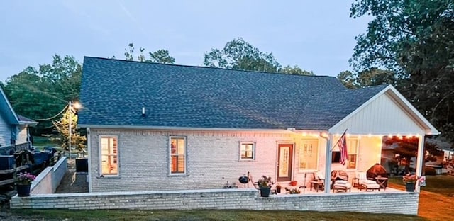 back of property featuring a patio area and a yard