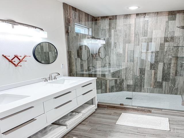 bathroom with vanity and a shower with shower door