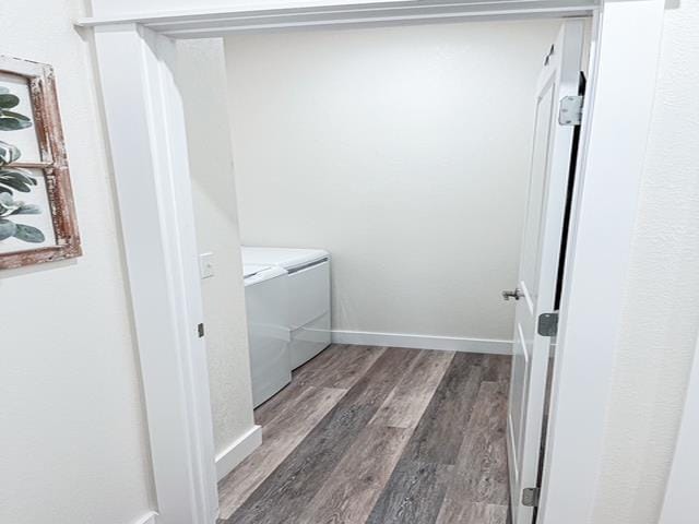 laundry room featuring washing machine and dryer and dark wood-type flooring