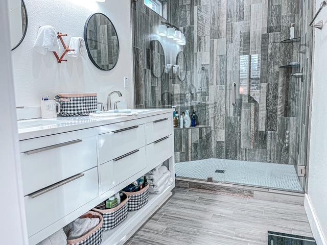 bathroom with vanity and a shower with shower door