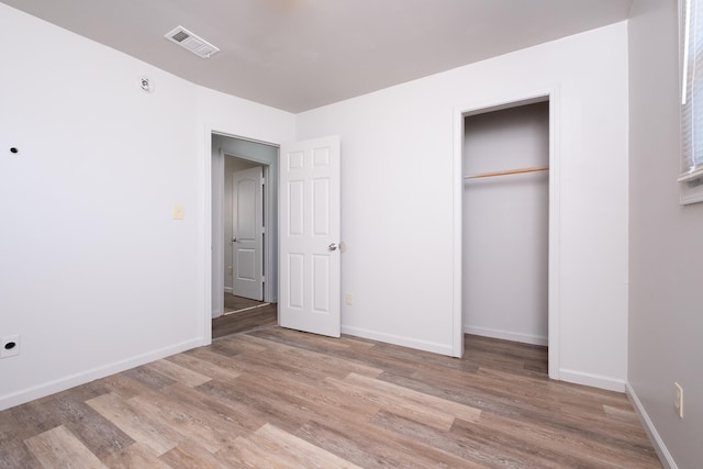 unfurnished bedroom featuring a closet and light hardwood / wood-style flooring