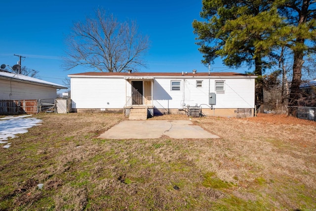 back of house with a yard and a patio