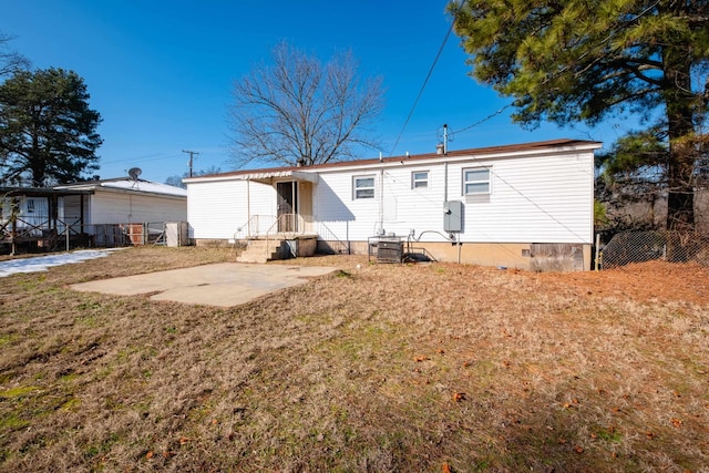 back of house with a patio area, cooling unit, and a yard