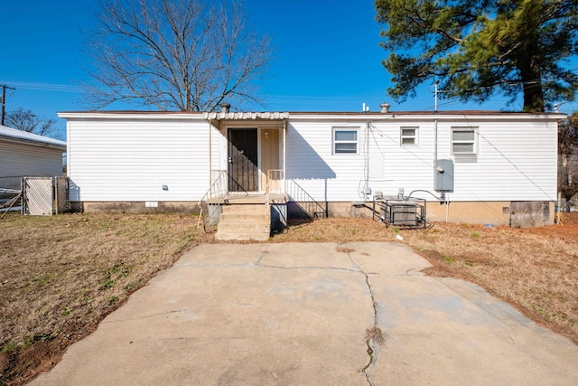 rear view of house featuring a patio area and a lawn