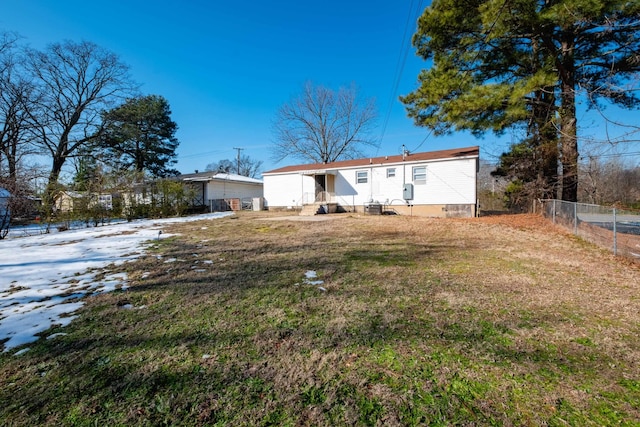 rear view of house featuring a yard