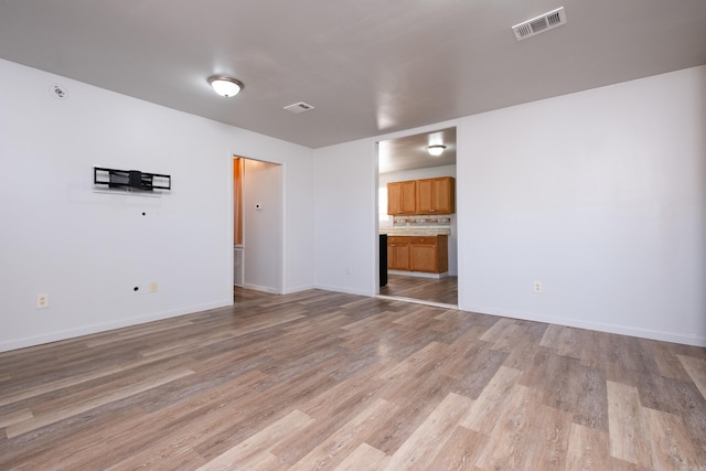 unfurnished living room featuring light hardwood / wood-style floors