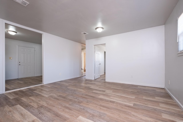 unfurnished room with light wood-type flooring