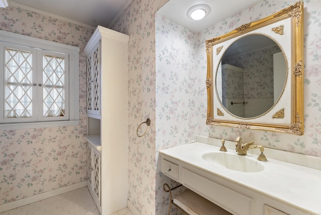 bathroom featuring sink, tile patterned floors, and crown molding