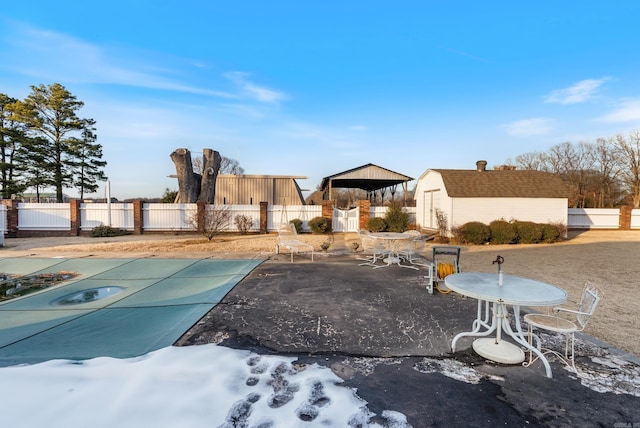 view of yard featuring a covered pool and a patio