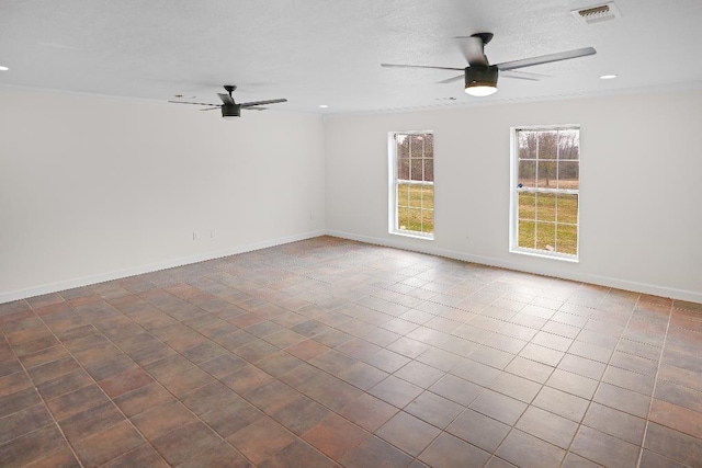 tiled empty room featuring ceiling fan