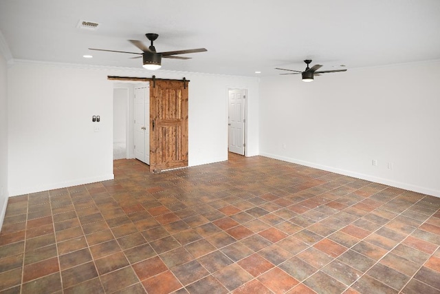 spare room with ceiling fan, ornamental molding, and a barn door