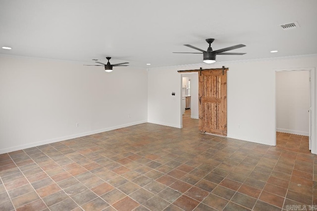 unfurnished room with ceiling fan, a barn door, and ornamental molding