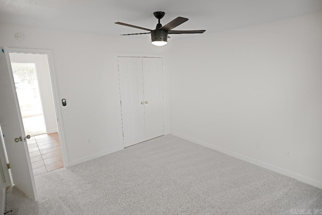 carpeted empty room with ceiling fan