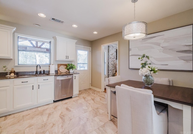 kitchen featuring dishwasher, white cabinets, hanging light fixtures, and sink