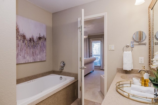 bathroom featuring a bathing tub, crown molding, and vanity