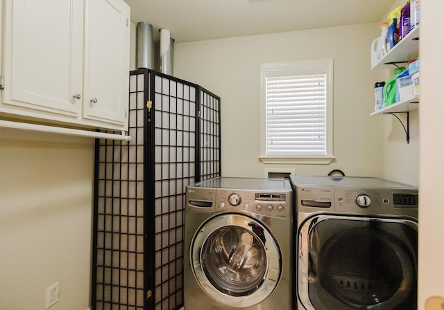 clothes washing area with cabinets and washer and dryer