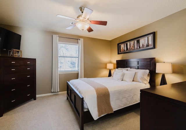 bedroom featuring ceiling fan and light colored carpet