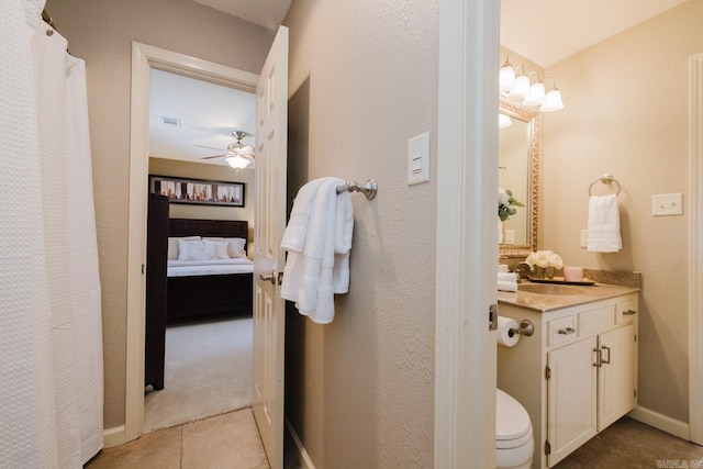 bathroom with ceiling fan, vanity, tile patterned floors, and toilet