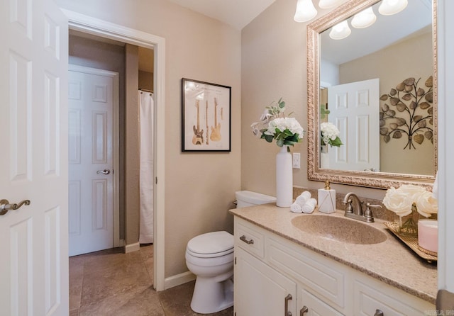 bathroom featuring toilet, tile patterned flooring, and vanity