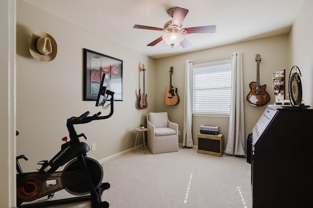 workout area with ceiling fan and light carpet