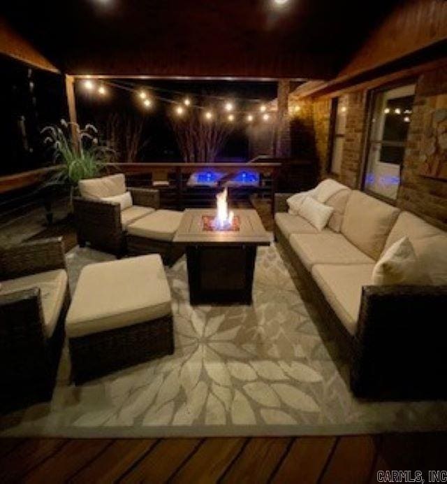 view of patio featuring an outdoor living space with a fire pit