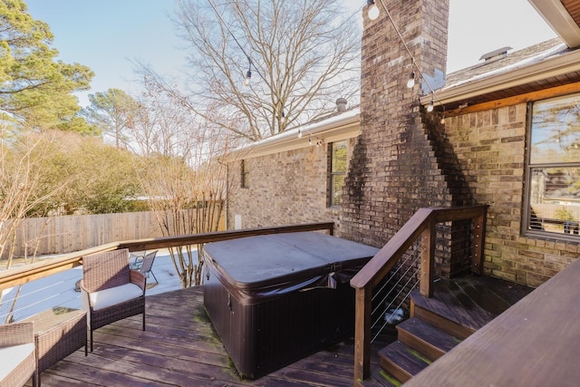 wooden terrace with a hot tub