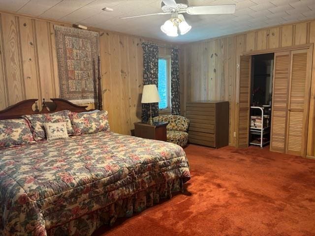 bedroom with ceiling fan, carpet, and wooden walls