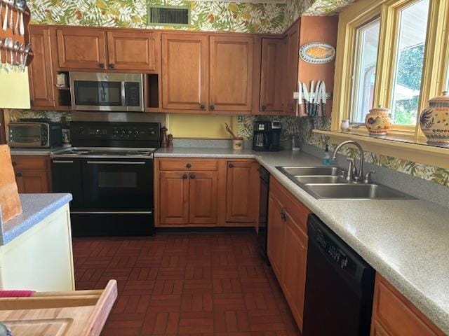 kitchen with black appliances and sink