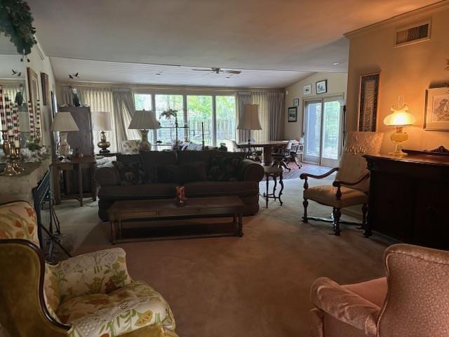 living room with ceiling fan, carpet, ornamental molding, and lofted ceiling