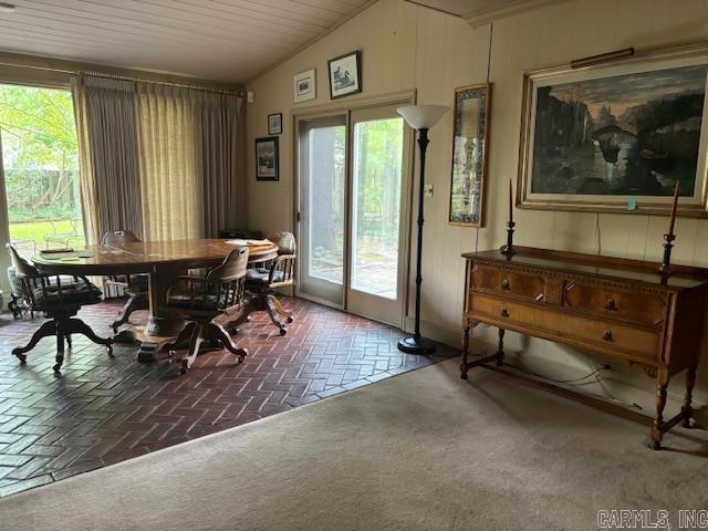 dining room with lofted ceiling and plenty of natural light