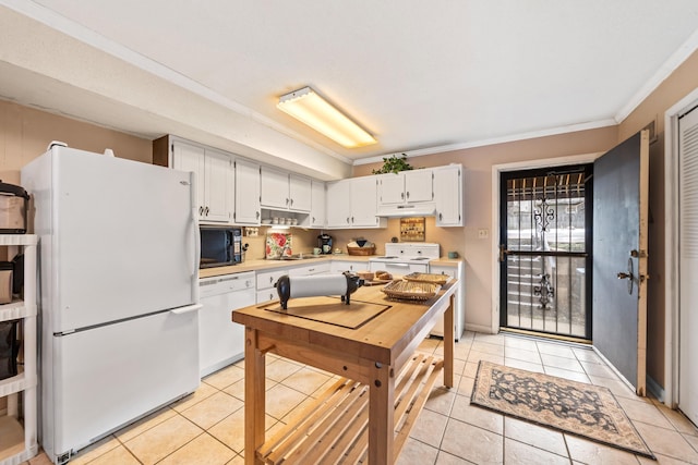 kitchen with light tile patterned floors, ornamental molding, white cabinets, and white appliances