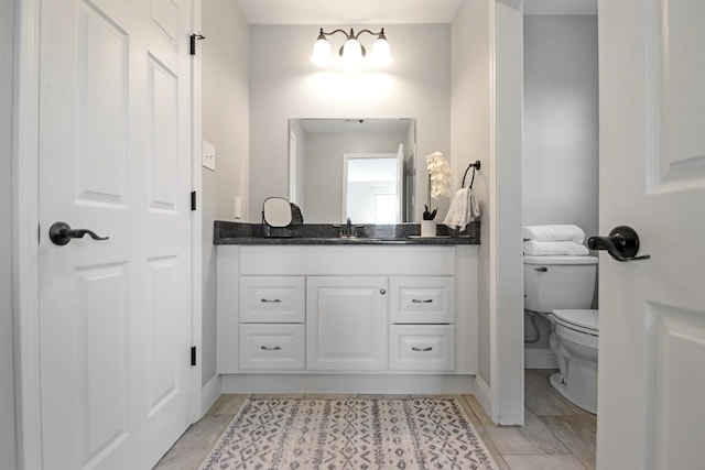 bathroom with toilet and vanity