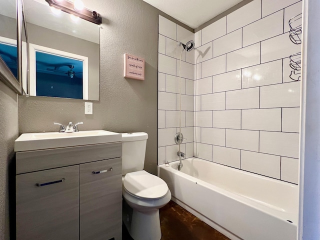 full bathroom featuring toilet, vanity, and tiled shower / bath