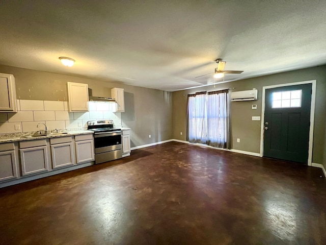 kitchen featuring a wall unit AC, decorative backsplash, plenty of natural light, electric range, and sink