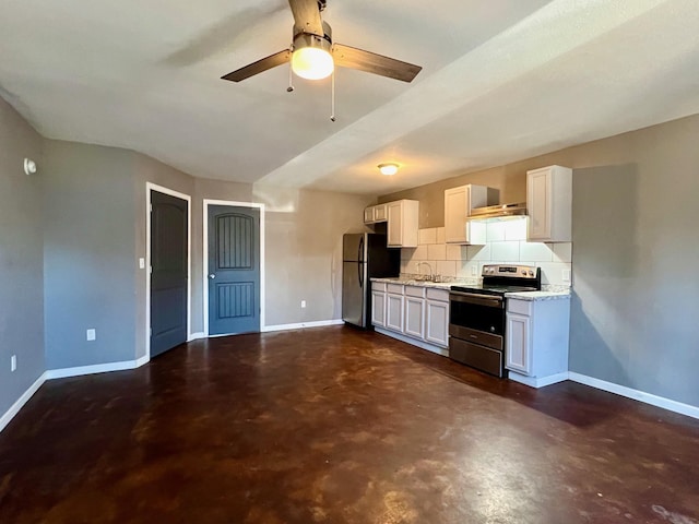 kitchen with stainless steel appliances, decorative backsplash, white cabinets, light stone counters, and sink