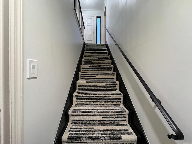 staircase featuring crown molding