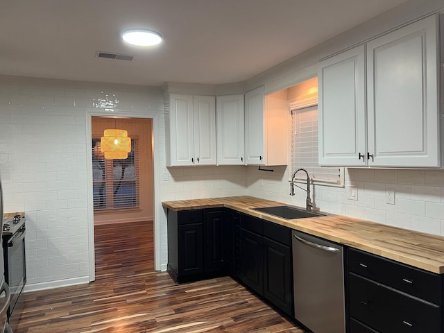 kitchen featuring appliances with stainless steel finishes, wood counters, white cabinetry, sink, and dark hardwood / wood-style floors