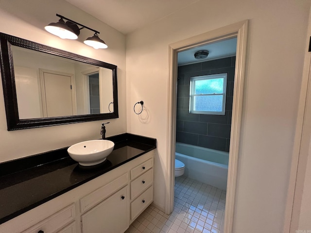 full bathroom with toilet, vanity, tiled shower / bath combo, and tile patterned flooring