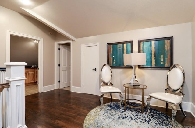 sitting room featuring lofted ceiling and hardwood / wood-style flooring