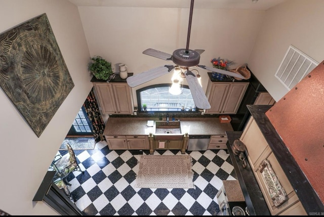 kitchen featuring dishwasher and a towering ceiling